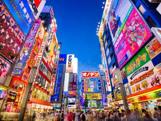 Akihabara Electric Town street with colourful neon signs anime billboards and crowds