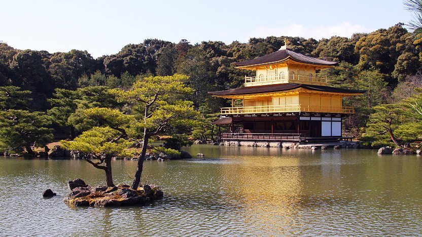 Kinkaku-ji Golden Pavilion temple reflecting in mirror pond surrounded by trees Kyoto