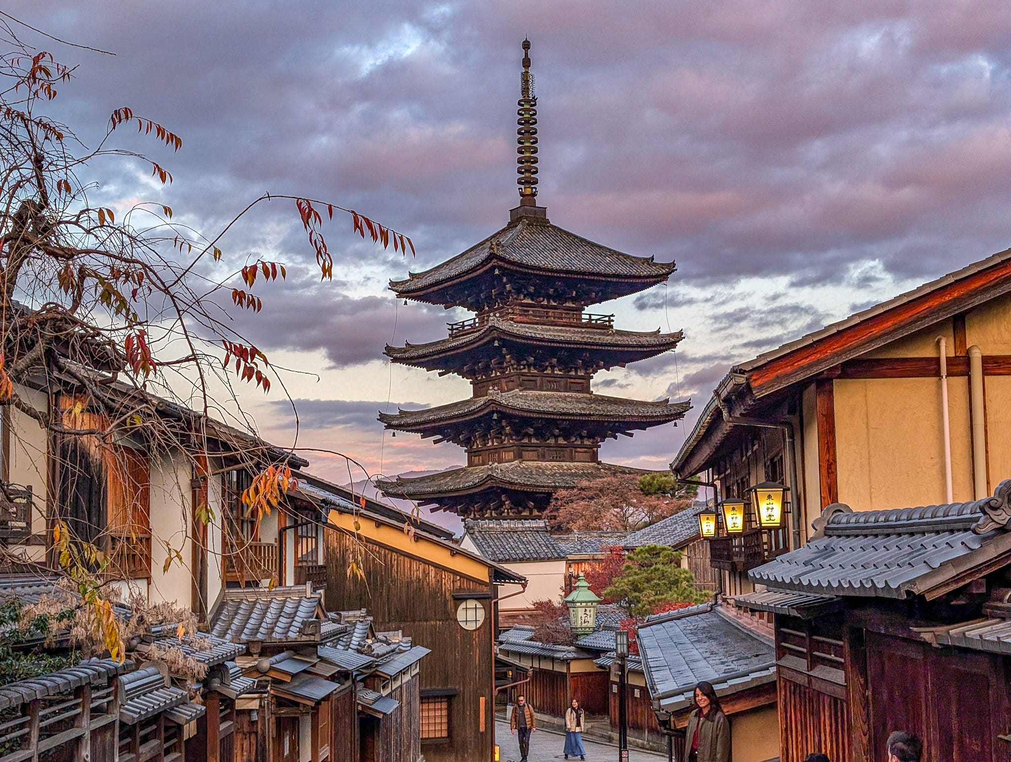 Kyoto pagoda at sunset with traditional street and autumn leaves